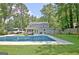 Backyard features a sparkling pool, lush greenery, ample space for outdoor lounging, and an RV at 345 Summer Pl, Peachtree City, GA 30269