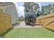 Fenced RV storage area with RV parked, gravel drive and lush grass at 345 Summer Pl, Peachtree City, GA 30269