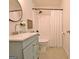 Bathroom with a blue vanity sink, round mirror, and a shower with white shower curtain at 345 Summer Pl, Peachtree City, GA 30269