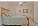 Light-filled bedroom with a ceiling fan, bed with light blue linens, and decorative wall art at 345 Summer Pl, Peachtree City, GA 30269
