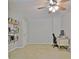 Bedroom featuring neutral paint, ceiling fan, and desk with built-in shelving at 345 Summer Pl, Peachtree City, GA 30269