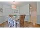 Charming dining room with a rustic table, seating for six, and a stylish light fixture creating a warm ambiance at 345 Summer Pl, Peachtree City, GA 30269