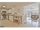 Bright, tiled kitchen flows into living room, with stainless appliances and breakfast seating at 345 Summer Pl, Peachtree City, GA 30269