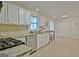 Well-lit kitchen featuring white cabinets, granite countertops, stainless steel appliances, and tile flooring at 345 Summer Pl, Peachtree City, GA 30269