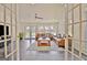 Open living room with french doors, tile flooring, and view of the swimming pool at 345 Summer Pl, Peachtree City, GA 30269