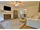 Spacious living room featuring a brick fireplace, plush seating, hardwood floors, and natural light at 345 Summer Pl, Peachtree City, GA 30269