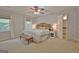 Bright main bedroom with a cozy sitting area, ceiling fan, and windows with curtains at 345 Summer Pl, Peachtree City, GA 30269