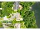 Aerial view of home featuring mature trees and waterfront proximity at 1919 Lake Lucerne Sw Way, Lilburn, GA 30047