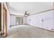 Large bedroom featuring neutral carpet, ceiling fan, and large window at 1919 Lake Lucerne Sw Way, Lilburn, GA 30047