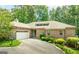 Charming brick home with a two-car garage and lush landscaping along a paved driveway at 1919 Lake Lucerne Sw Way, Lilburn, GA 30047