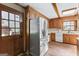 Updated kitchen with stainless steel refrigerator, wood cabinets, and laminate floor at 1919 Lake Lucerne Sw Way, Lilburn, GA 30047