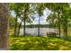 Picturesque lake view framed by trees, showcasing the serene waterfront setting at 1919 Lake Lucerne Sw Way, Lilburn, GA 30047