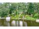 Lake view featuring waterfront home with a private dock and boat house at 1919 Lake Lucerne Sw Way, Lilburn, GA 30047