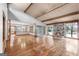 Expansive living room features hardwood floors, a stone fireplace, and picturesque views of the lake at 1919 Lake Lucerne Sw Way, Lilburn, GA 30047