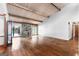Bright living room featuring hardwood floors, a stone fireplace, high ceilings, and access to the lakefront at 1919 Lake Lucerne Sw Way, Lilburn, GA 30047