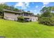 Home's backyard with a lush lawn and screened in porch at 110 Mourning Dove S Dr, Fayetteville, GA 30215