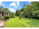 Large backyard with lush lawn, mature trees, and shed at 110 Mourning Dove S Dr, Fayetteville, GA 30215
