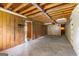 Basement with paneled walls and open wood ceiling beams at 110 Mourning Dove S Dr, Fayetteville, GA 30215