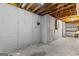 Unfinished basement featuring concrete walls, exposed beams, and wire shelving at 110 Mourning Dove S Dr, Fayetteville, GA 30215