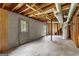 Unfinished basement with concrete walls and exposed wood beams and ductwork at 110 Mourning Dove S Dr, Fayetteville, GA 30215