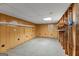 Unfinished basement featuring wood paneled walls and exposed ceiling at 110 Mourning Dove S Dr, Fayetteville, GA 30215