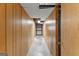 Long basement hallway with wood-paneled walls leading to storage space at 110 Mourning Dove S Dr, Fayetteville, GA 30215