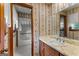 Vintage bathroom with sink and a tub with shower and classic wallpaper at 110 Mourning Dove S Dr, Fayetteville, GA 30215