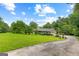 Scenic property with a sprawling green lawn, a long driveway, and mature trees surrounding the home at 110 Mourning Dove S Dr, Fayetteville, GA 30215