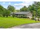 Charming single-story home with a well-manicured lawn and mature landscaping at 110 Mourning Dove S Dr, Fayetteville, GA 30215