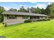 Charming single-story home with lush green lawn, mature trees, and inviting front porch at 110 Mourning Dove S Dr, Fayetteville, GA 30215