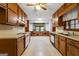 Traditional kitchen featuring wood cabinets, laminate countertops, and a bright window at 110 Mourning Dove S Dr, Fayetteville, GA 30215