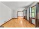 Open-concept living room with hardwood floors, large windows, and a view into the dining room at 110 Mourning Dove S Dr, Fayetteville, GA 30215