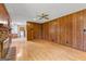 Spacious living room featuring wood paneling and hardwood floors at 110 Mourning Dove S Dr, Fayetteville, GA 30215