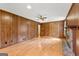 Large living room with wood paneling, hardwood floors and a brick fireplace at 110 Mourning Dove S Dr, Fayetteville, GA 30215