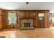 Spacious living room with wood paneling, fireplace, and hardwood floors at 110 Mourning Dove S Dr, Fayetteville, GA 30215