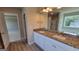 Bathroom with a double vanity, granite countertop, modern fixtures, and a view into the shower at 45 Duffy Dr., Mcdonough, GA 30253