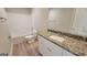 Bathroom featuring granite countertop, white cabinets, and a tub with a shower at 45 Duffy Dr., Mcdonough, GA 30253