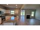 Open-concept kitchen with granite countertops, white cabinets, stainless steel appliances, and views to the living room at 45 Duffy Dr., Mcdonough, GA 30253