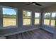 Bright sunroom with large windows offering expansive views of the surrounding landscape and a ceiling fan at 45 Duffy Dr., Mcdonough, GA 30253