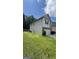 A view of the rear of the home showing neutral siding, green grass and a fenced in yard at 5753 Barrington Run # 114, Union City, GA 30291