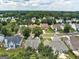 Aerial view highlights a residential neighborhood with mature trees and well-maintained properties at 1735 Deer Crossing Cir, Jonesboro, GA 30236