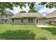 Exterior backyard featuring siding, concrete patio, and green lawn at 1735 Deer Crossing Cir, Jonesboro, GA 30236
