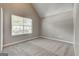 Bright bedroom featuring vaulted ceiling, plush carpet and a window at 1735 Deer Crossing Cir, Jonesboro, GA 30236