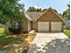 Charming single-story brick home with a two-car garage and well-manicured lawn at 1735 Deer Crossing Cir, Jonesboro, GA 30236