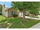 Exterior shot of a brick home with a two-car garage and established trees on the lawn at 1735 Deer Crossing Cir, Jonesboro, GA 30236