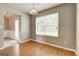 Eat-in kitchen with wood cabinets, laminate floors, and a bright window at 1735 Deer Crossing Cir, Jonesboro, GA 30236