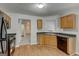 Well-lit kitchen featuring wood cabinets, neutral countertops, and black appliances at 1735 Deer Crossing Cir, Jonesboro, GA 30236