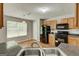 Open kitchen with stainless steel sink, black appliances, and lots of natural light at 1735 Deer Crossing Cir, Jonesboro, GA 30236