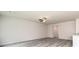 Spacious living room featuring gray wood floors, a ceiling fan, and natural light at 102 Avondale Blvd, Conyers, GA 30013