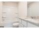 Bright bathroom with a shower-tub combo and granite vanity at 282 Limestone Circle, Conyers, GA 30013